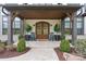 Inviting front porch with double doors, rocking chairs and fresh landscaping at 17416 Gillican Overlook Rd, Davidson, NC 28036