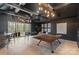 Entertaining game room featuring high ceilings, modern lighting, and a ping pong table with a picturesque view at 17416 Gillican Overlook Rd, Davidson, NC 28036