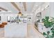 Bright kitchen with a marble island, stainless steel appliances, wooden beams, and pendant lights at 17416 Gillican Overlook Rd, Davidson, NC 28036