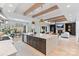 Open concept kitchen flows into dining and living areas with fireplace and abundant natural light at 17416 Gillican Overlook Rd, Davidson, NC 28036