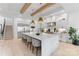 Bright, open kitchen features a large island with seating, stainless steel appliances, and wooden beam accents at 17416 Gillican Overlook Rd, Davidson, NC 28036