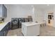 Spacious laundry room with modern washer and dryer and folding island at 17416 Gillican Overlook Rd, Davidson, NC 28036
