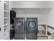 Convenient laundry room with modern washer and dryer, ample shelving, and storage solutions for efficiency at 17416 Gillican Overlook Rd, Davidson, NC 28036