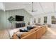 Bright living room boasts vaulted ceilings, a large TV, neutral decor, and abundant natural light at 17416 Gillican Overlook Rd, Davidson, NC 28036