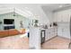 Open-concept living room with vaulted ceilings, hardwood floors, and seamless flow to the kitchen area at 17416 Gillican Overlook Rd, Davidson, NC 28036
