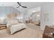 Serene main bedroom featuring light-toned decor, a cozy sitting area, and a stylish ceiling fan for added comfort at 17416 Gillican Overlook Rd, Davidson, NC 28036