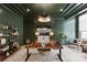 Dark green office space with designer lighting, modern desk, and comfortable seating area at 17416 Gillican Overlook Rd, Davidson, NC 28036