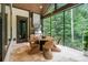 Covered patio with stainless steel grill, dining table, and natural views, great for entertaining at 17416 Gillican Overlook Rd, Davidson, NC 28036