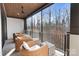 Relaxing outdoor living space with comfortable wicker furniture and scenic views of the surrounding trees and sky at 17416 Gillican Overlook Rd, Davidson, NC 28036