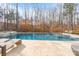 Beautiful in-ground pool and stone patio with lounge chairs at 17416 Gillican Overlook Rd, Davidson, NC 28036