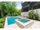A luxurious backyard offers a gorgeous pool, lounge chairs and an incredible outdoor living space at 17416 Gillican Overlook Rd, Davidson, NC 28036