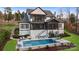 Outdoor pool area with seating, lounge chairs, and well-maintained landscaping at 17416 Gillican Overlook Rd, Davidson, NC 28036