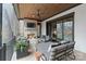 Cozy screened porch with stone fireplace, ceiling fan and comfortable seating at 17416 Gillican Overlook Rd, Davidson, NC 28036