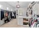 Spacious walk-in closet with custom shelving and a decorative light fixture at 17416 Gillican Overlook Rd, Davidson, NC 28036