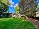 Expansive backyard with lush green lawn and mature trees, offering a private and serene outdoor space at 1809 The Plaza None, Charlotte, NC 28205