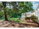 Spacious backyard features a brick patio, fire pit, and a lush lawn shaded by mature trees at 1809 The Plaza None, Charlotte, NC 28205