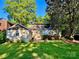 Spacious backyard with a detached structure, green lawn, and mature trees, ideal for relaxation and outdoor activities at 1809 The Plaza None, Charlotte, NC 28205