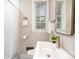 Bathroom showcasing a modern sink, subway tile, shower with curtain, and bright natural light at 1809 The Plaza None, Charlotte, NC 28205