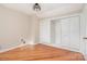 Bright bedroom with wood floors, featuring natural light and a spacious closet at 1809 The Plaza None, Charlotte, NC 28205