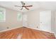 Bedroom showcasing a ceiling fan, hardwood floors, and bright natural light from windows at 1809 The Plaza None, Charlotte, NC 28205