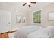 Cozy bedroom with hardwood floors, natural light, and a ceiling fan at 1809 The Plaza None, Charlotte, NC 28205