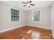 Bedroom featuring wood floors, neutral paint, ceiling fan, and large windows at 1809 The Plaza None, Charlotte, NC 28205