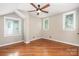 Bright bedroom featuring hardwood floors, natural light, and a ceiling fan at 1809 The Plaza None, Charlotte, NC 28205