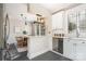 Bright kitchen with white cabinets, stainless steel appliances, marble countertops, and an adjacent dining area at 1809 The Plaza None, Charlotte, NC 28205