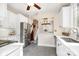 Bright kitchen features white cabinets, stainless appliances, stone countertops, and opens to the dining area at 1809 The Plaza None, Charlotte, NC 28205
