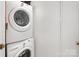 Efficient laundry space features a stacked washer and dryer with easy access at 1809 The Plaza None, Charlotte, NC 28205