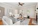 Cozy living room with hardwood floors, a fireplace, and comfortable white furniture at 1809 The Plaza None, Charlotte, NC 28205