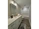 Bathroom with white cabinets, granite countertop, a framed mirror, and a shower/tub at 2012 Crown Point Dr # A, Albemarle, NC 28001