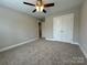 This bedroom features neutral walls, carpet, a ceiling fan, and a closet at 2012 Crown Point Dr # A, Albemarle, NC 28001