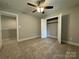 Bedroom with open closet doors and access to another room or closet; versatile and inviting at 2012 Crown Point Dr # A, Albemarle, NC 28001