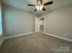 Bright bedroom showcasing a ceiling fan and access to a walk-in closet and other rooms at 2012 Crown Point Dr # A, Albemarle, NC 28001