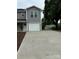 A long concrete driveway leads to a well-maintained home with neutral gray siding and white trim at 2012 Crown Point Dr # A, Albemarle, NC 28001