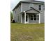 Gray two-story home featuring a covered patio, lush lawn, and classic architectural design at 2012 Crown Point Dr # A, Albemarle, NC 28001