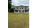 Two story exterior showing gray siding, roof, and a large green yard at 2012 Crown Point Dr # A, Albemarle, NC 28001