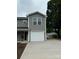 Exterior shot showcasing a modern townhome with gray siding, white trim, and a well-manicured yard and driveway at 2012 Crown Point Dr # A, Albemarle, NC 28001