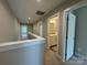 Carpeted hallway with view of a full bathroom with a vanity and granite countertop at 2012 Crown Point Dr # A, Albemarle, NC 28001