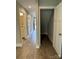 Hallway features an under-stair closet, a half-bathroom, and wood-look flooring at 2012 Crown Point Dr # A, Albemarle, NC 28001