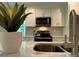 Modern kitchen with white cabinets, stainless steel appliances, and a sink set in stylish countertop at 2012 Crown Point Dr # A, Albemarle, NC 28001