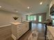 Open floor plan featuring a modern kitchen island with sink, dishwasher, and additional counter space at 2012 Crown Point Dr # A, Albemarle, NC 28001