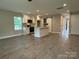 Open floor plan showing a kitchen island, shaker cabinets and stainless appliances from the living area at 2012 Crown Point Dr # A, Albemarle, NC 28001