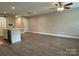 Open-concept living space showcases a kitchen island with a stainless sink and modern ceiling fan at 2012 Crown Point Dr # A, Albemarle, NC 28001