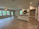 Open concept living space featuring sleek flooring, a bright kitchen, and sliding door access at 2012 Crown Point Dr # A, Albemarle, NC 28001