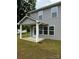 Patio with concrete floor, white support columns and a green backyard at 2012 Crown Point Dr # A, Albemarle, NC 28001