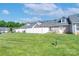 Backyard view of townhome featuring well-maintained lawn, white fence and a clear blue sky at 2153 Pavilion Ct, Rock Hill, SC 29732