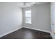 Bright bedroom featuring dark hardwood floors, a modern ceiling fan, and a large window for natural light at 2153 Pavilion Ct, Rock Hill, SC 29732