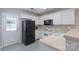 Well-lit kitchen featuring white cabinets, modern appliances, and stylish black and white tile flooring at 2153 Pavilion Ct, Rock Hill, SC 29732